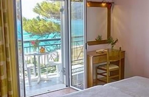 Agios Georgios Pagon Apartment | Maria's apartment 1 - right on the beach with sea views in the beautiful bay of Agios Georgios Pago