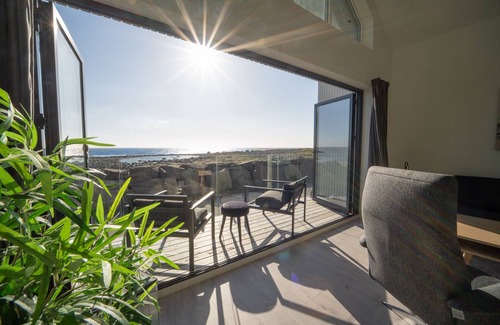 Vestbygd House | New vacation home by the sea with glass front, fireplace & boat. Pet friendly