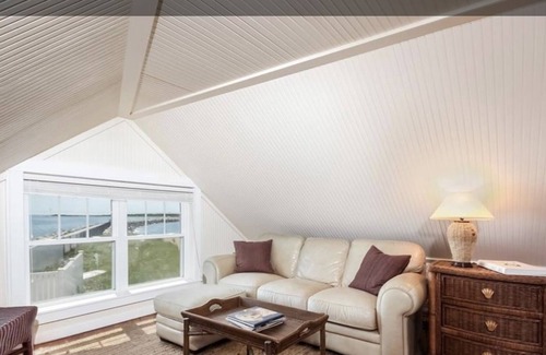 Adamsville Cottage | Oceanfront Cottage with Private Beach and Courtyard. Outside Bar & Fire Table.