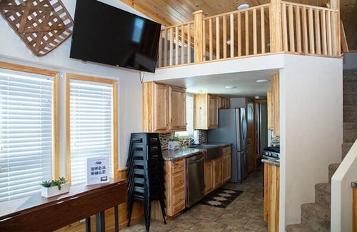 Meeker House | Our largest "not so tiny" tiny home, White River Casita is a beautiful modern tiny home that features a Queen bed on main level, one Queen bed in loft accessible by stairs, one Queen fold out couch with additional sleeping space in loft for sleeping