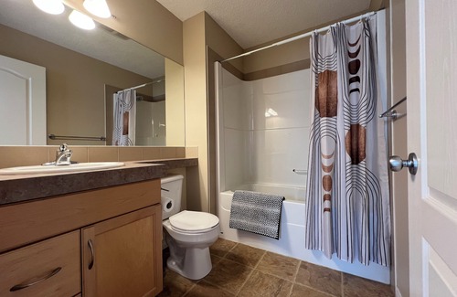 Airdrie House | Private bedroom and bathroom