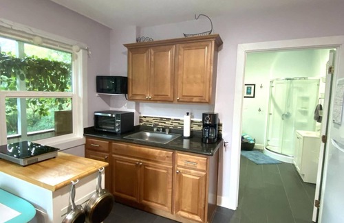 Makaha Apartment | Private, country living modern conveniences. Tropical farm, steps from the beach