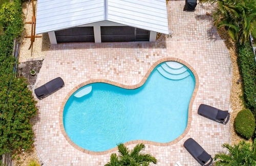 Naples Park House | Relax by the sand at nearby Vanderbilt Beach or hang by heated pool