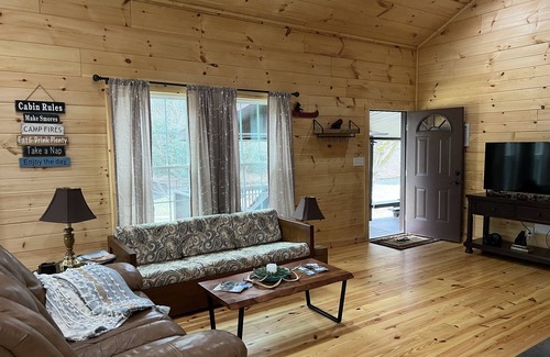 Newland Cabin | Riverfront Luxury Log Cabin with outside fire pit and deck overlooking the water