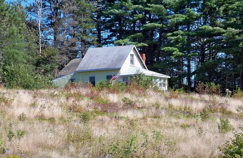 Dennysville Cottage | Rustic, two-story, clapboard cottage, field view, Pet-friendly, Downeast Maine