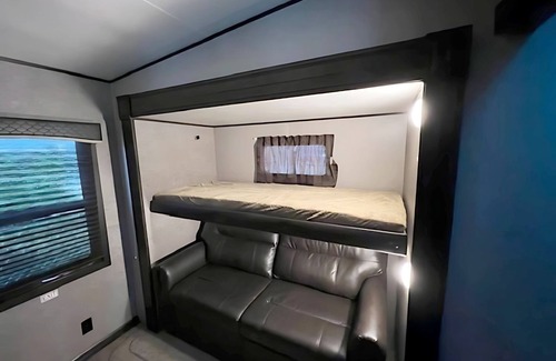 Kenora Resort | RV 5 Rustic Charm w/Queen Bed with Forest Background