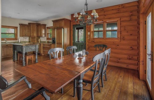 Huntly House | Secluded 4 bedroom log style home with screened porches, deck and fishing pond.