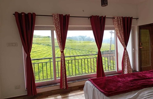 West Mere House | Spacious and serene space with Tea Estate view from every room.n