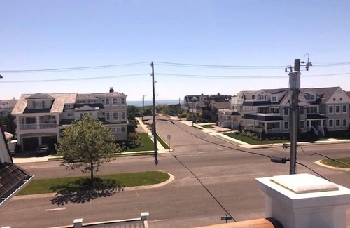 Avalon House | Spacious deck has ocean views as home is across the street from the beachblock.