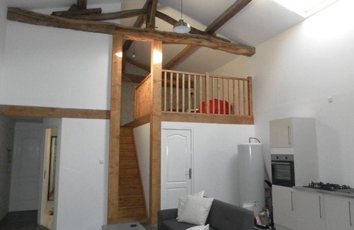 Soumeras House | Spacious, double height, beamed main space. This gite is in a rural setting.