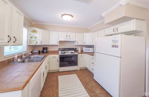 Holmes Beach Villa | Steps to the Beach with Shared Heated Salt Pool and Private Backyard & Grill