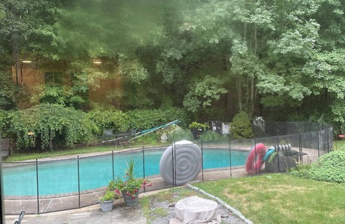 Greenwich House | Summer retreat with salt water pool on tranquil woods.