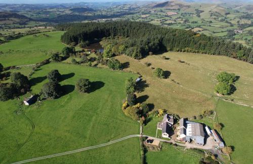 Oswestry House | The Granary at Pentregaer Ucha, tennis court & lake.