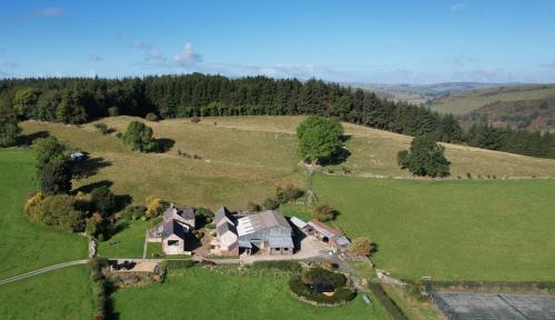 Oswestry House | The Granary at Pentregaer Ucha, tennis court & lake.