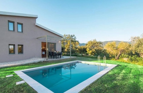 Doukades Villa | The villa's large private garden leads directly to the outdoor private pool.