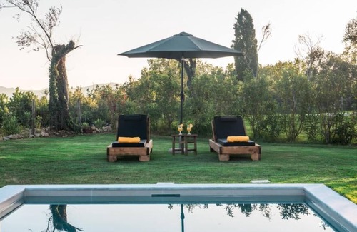 Doukades Villa | The villa's large private garden leads directly to the outdoor private pool.