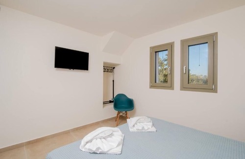 Doukades Villa | The villa's large private garden leads directly to the outdoor private pool.