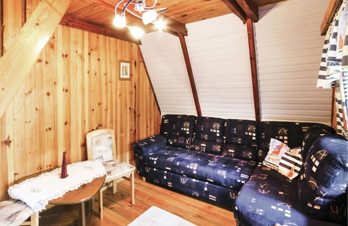 Barczewo House | This cottage is located on a small hill, directly on the lake with its own jetty.