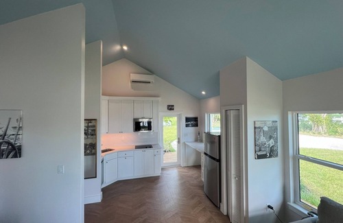 Jensen Beach House | Waterfront luxury bungalow with private beach, paddleboards, kayaks and bikes!