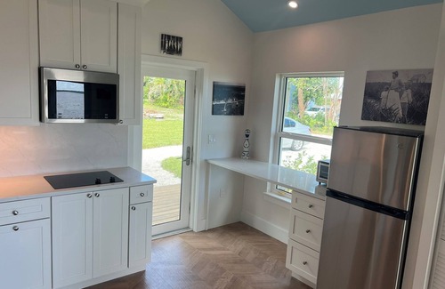 Jensen Beach House | Waterfront luxury bungalow with private beach, paddleboards, kayaks and bikes!
