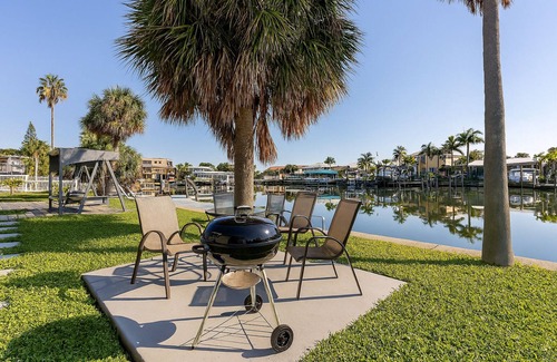 Capri Isle Condo | Waterfront Treasure Island Oasis, Dock, Sunsets & Walk to Beach + John’s Pass
