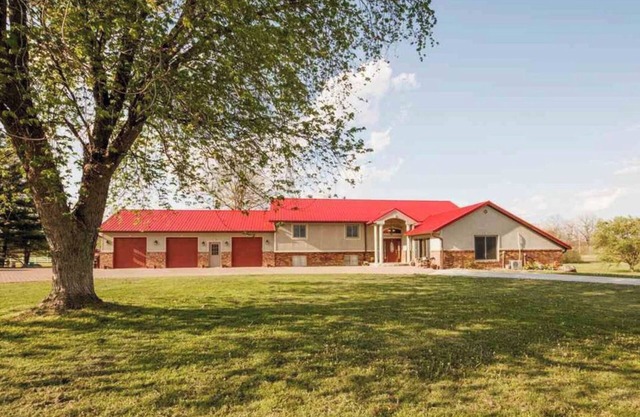 A MANSION WITH A HUGE INDOOR HEATED SWIMMING POOL WITH A BONUS THEATER ROOM.