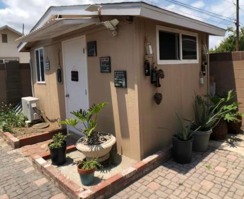 A small room in the backyard with a full bed