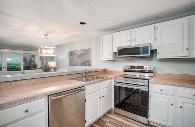 Beachwalk 115 - Pine Knoll Shores Oceanfront Condo! Steps to beach. Sleeps 8!