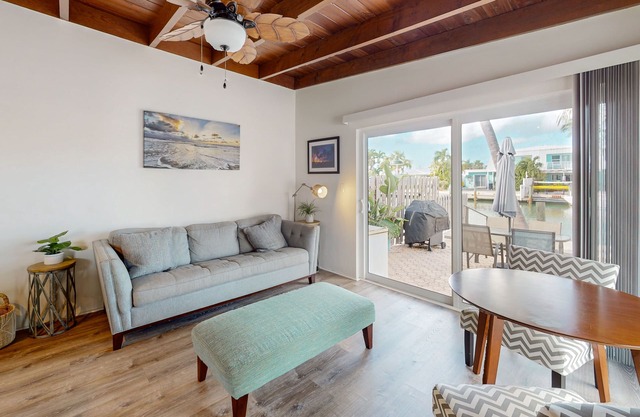 Beachy getaway with pool, water views, furnished patio, & dock access