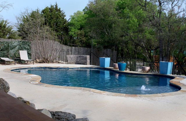 Canvas Tipi on wooden deck overlooking a season creek.