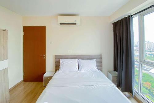 Cozy and Enjoy Living 2BR Tifolia Apartment By Travelio