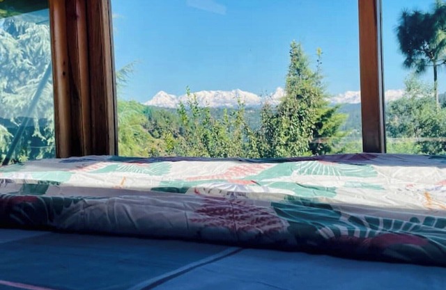 Cozy bungalow nestled in the Himalayas, snow-capped peaks, Kumaoni culture.