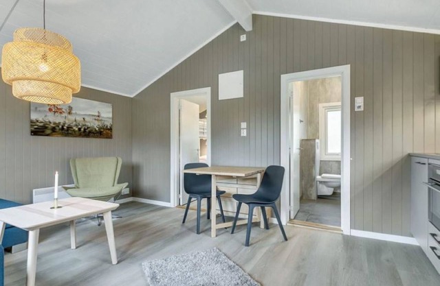 "Cozy cabin surrounded by nature and fjords, perfect for a peaceful moment."