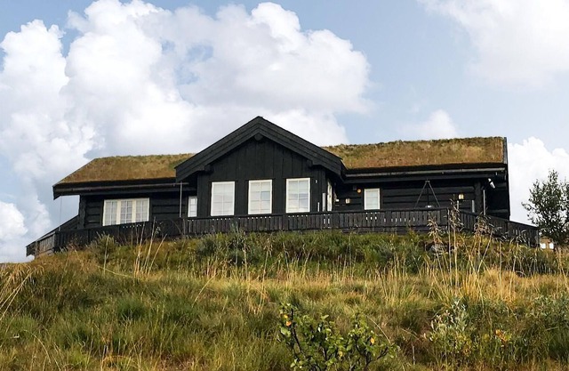 Cozy log cabin with sauna and mountain view.