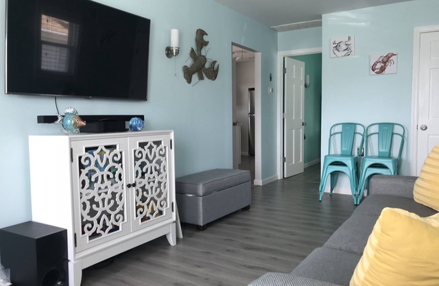 Enjoy sunsets at this modern cottage with large backyard and peekaboo bay view.