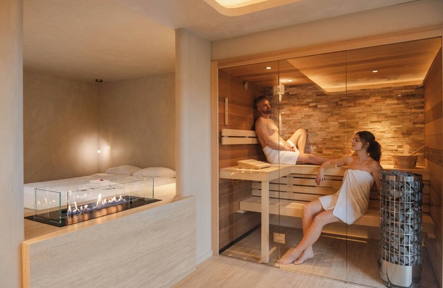Experience luxury and relaxation in the Wellness Suite, featuring a sauna, jacuzzi, and a serene forest-edge location.