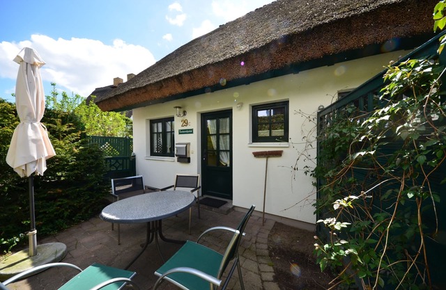 Historical Thatched with a separate entrance with transom windows and shutters