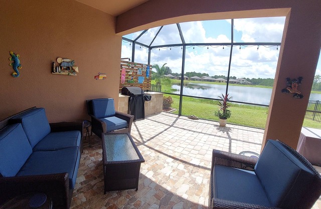 Lake view home with a screened outdoor entertainment area.