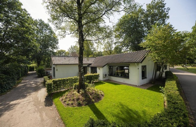 Luxurious group accommodation with stylish decor, modern amenities, six bedrooms, spacious kitchen, and garden, ideal for a relaxing stay.