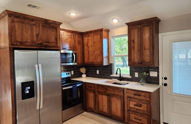 Modern-style cabin, located in rustic farmland near Bend, TX.