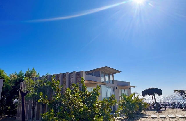 Nice bungalow on the beach, in front of the warm and calm sea.