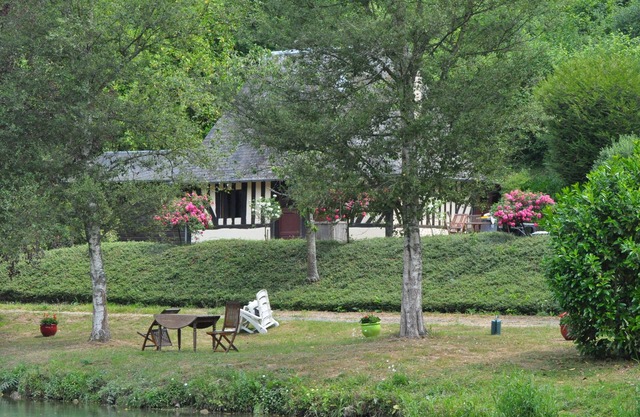 Norman house surrounded by nature with lake