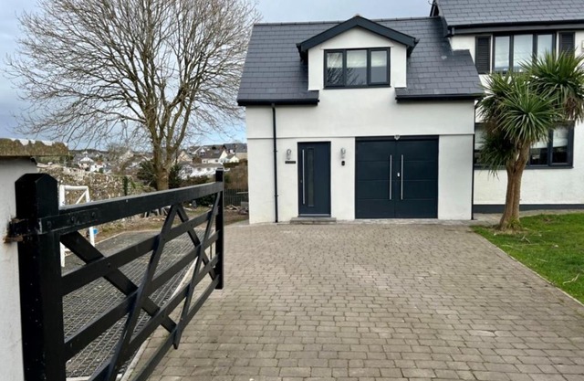 Orchard Lodge -Coastal Retreat, new build, village views, private garden and terrace