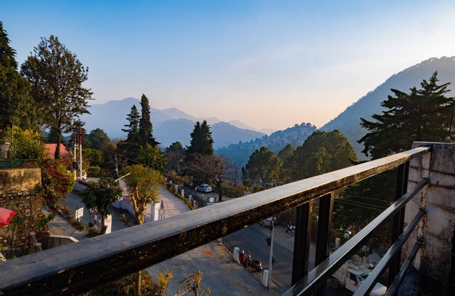 Peaceful, scenic, surrounded by green or snowy hills, far away from the city.