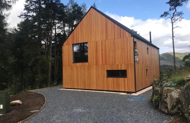 Red Stag with stunning loch and waterfall view