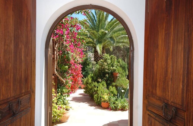Relaxation in Mediterranean garden landscape at the large private pool