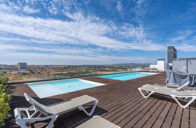 Rooftop Pools and Balcony Haven by HostWise