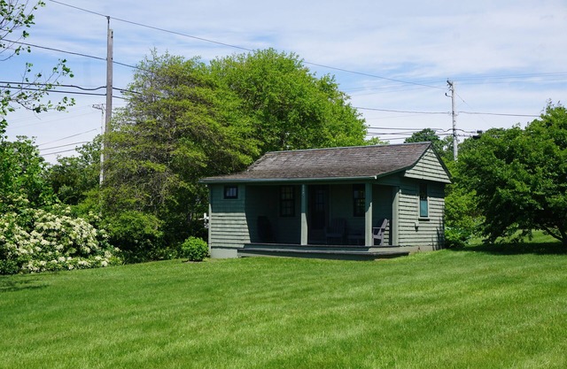 Sakonnet Point water view cottage with 8 minute walk to idyllic private beach .