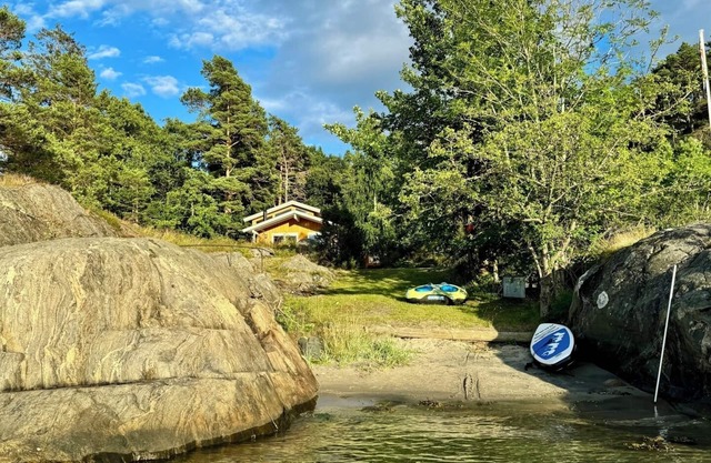 Seaside cabin with boat and beach in Kragerø