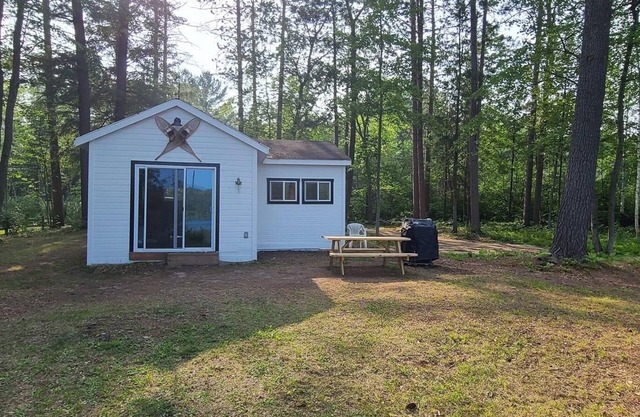 Serene cottage on private lake! Enjoy a private dock, fire pit, canoe, & more!